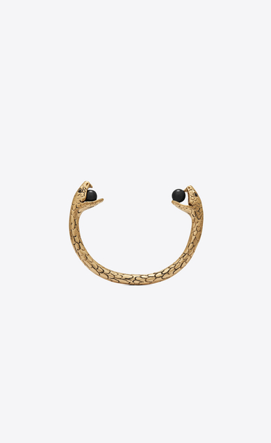 Snake bracelet in gold metal with black glass beads.